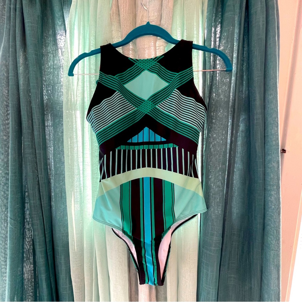 One piece swimsuit in blue and green geometric print.